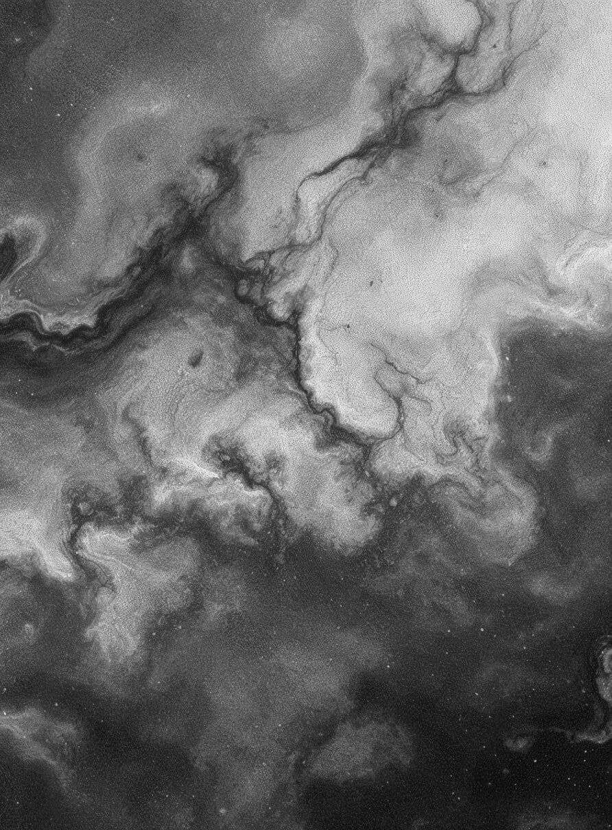 A black and white image depicting an abstract swirling pattern resembling a cloudy sky or cosmic nebula. The texture is ethereal and fluid, with contrasting light and dark areas creating a sense of depth and movement.